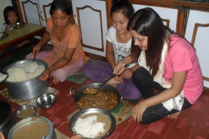 sister serving food to children